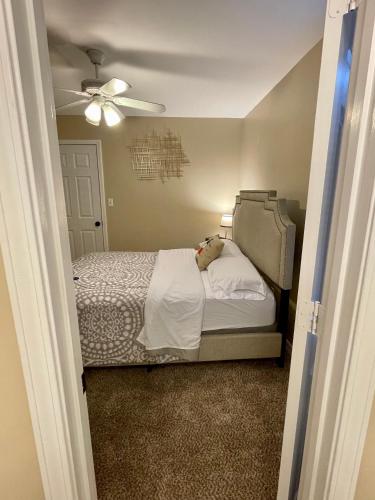 a bedroom with a bed and a ceiling fan at Bayou and Beyond: The perfect stay in Monroe