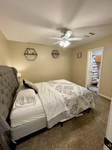 a bedroom with a bed and a ceiling fan at Bayou and Beyond: The perfect stay in Monroe