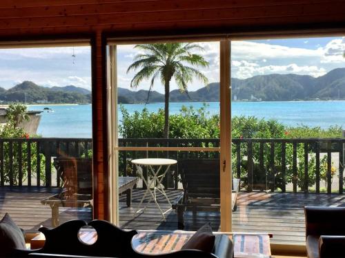 a view of the ocean from the porch of a house at Villa AdanRose Amami - Vacation STAY 06112v in Amami
