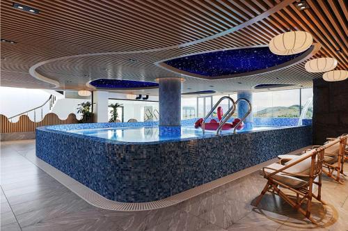 a lobby with a blue counter with red shoes on it at Bamboo Sapa Hotel in Sa Pa