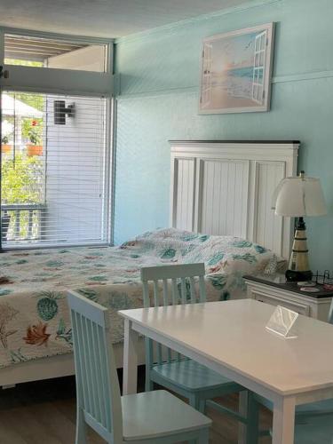 a bedroom with a bed and a table and chairs at Cedar Key Florida Condo at Park Place in Cedar Key
