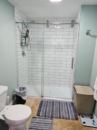 a bathroom with a shower and a toilet at Amazing cozy fully private studio in London