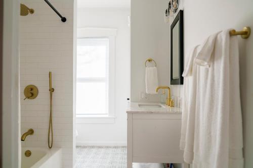 a white bathroom with a sink and a shower at Very Cozy, 2 Bedroom Farmhouse Apartment 2nd FL in Lancaster