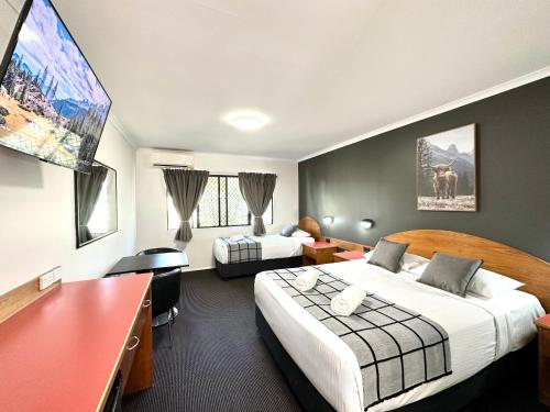 Postel nebo postele na pokoji v ubytování Mackay Resort Motel