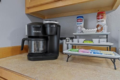 a coffee maker sitting on top of a counter at Waterfront Home with Pool, Hot Tub and Game Area in Shoreline Park