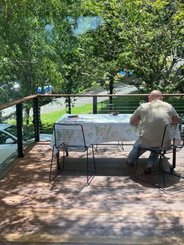 a man sitting at a table in a park at High Country Retreat in Jamieson