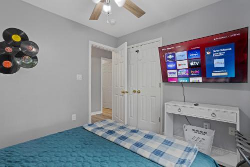 a bedroom with a bed and a flat screen tv at Waterfront Home with Pool, Hot Tub and Game Area in Shoreline Park