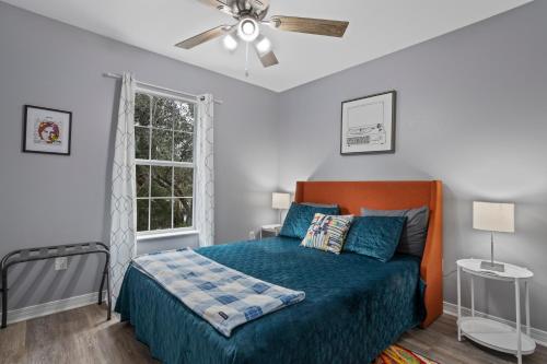 a bedroom with a bed and a ceiling fan at Waterfront Home with Pool, Hot Tub and Game Area in Shoreline Park
