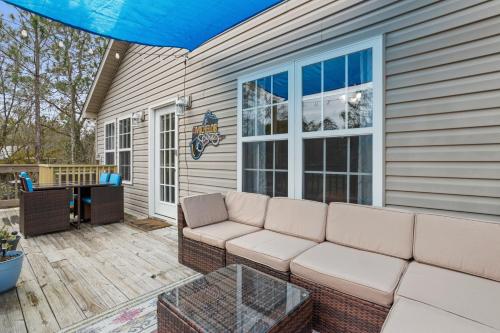 a patio with a couch and a table at Waterfront Home with Pool, Hot Tub and Game Area in Shoreline Park