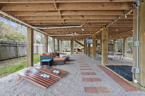 a covered patio with couches and a table at Waterfront Home with Pool, Hot Tub and Game Area in Shoreline Park