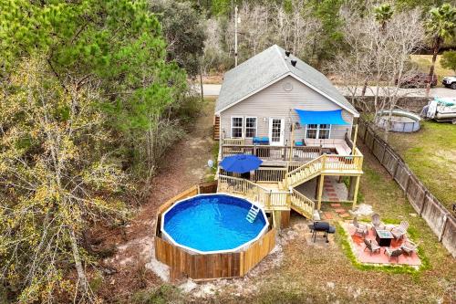 an aerial view of a house with a swimming pool at Waterfront Home with Pool, Hot Tub and Game Area in Shoreline Park