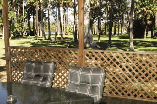 two chairs and a table on a gazebo at Smugglers Cove Holiday Village in Forster