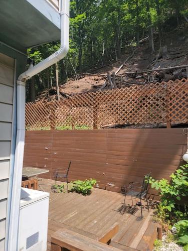 a wooden deck with two chairs and a table at Rock Pad AirBnB in New Haven
