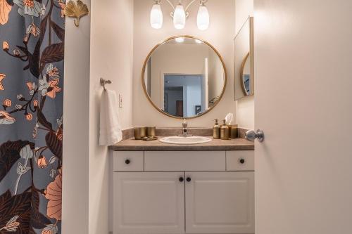 a bathroom with a sink and a mirror at Seattle Among The Trees: in Belltown w/Parking! in Seattle