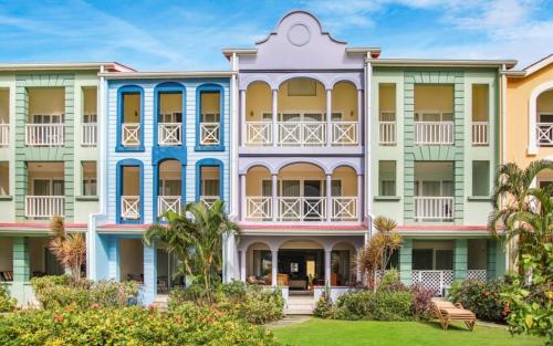 a row of colorful apartment buildings at Waterfront 2-bed townhouse - Harbour 17 townhouse in Gros Islet