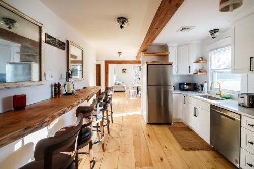 a kitchen with a long counter and a refrigerator at Charming Farmhouse near Bird in Hand in Lancaster