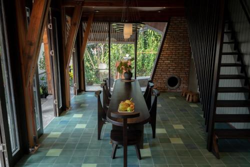 a dining room with a table and chairs at Ducampo House Dalat in Da Lat