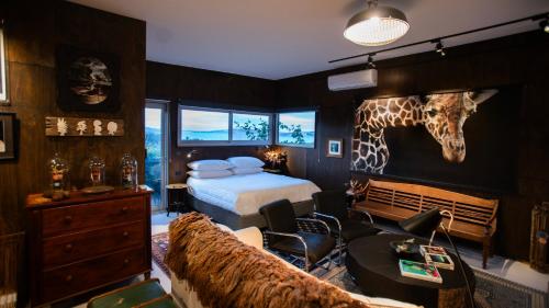 a bedroom with a bed and a giraffe head on the wall at The Hill House Panorama in Woodbridge
