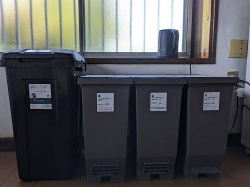 a group of three trash cans sitting next to a window at 古民家一軒貸切/BBQコンロ・プラレール貸出/無料パーキング　[しずこのいえ] in Tochigi