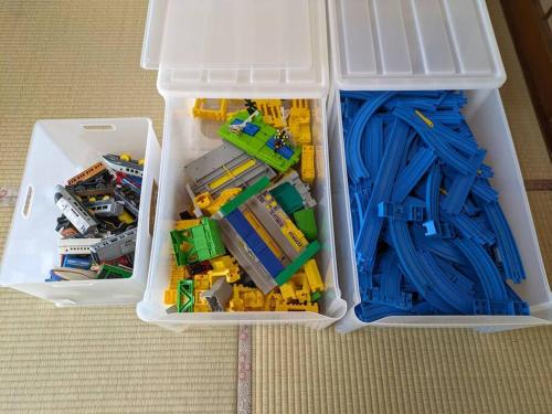 two white chests filled with legos and a toy truck at 古民家一軒貸切/BBQコンロ・プラレール貸出/無料パーキング　[しずこのいえ] in Tochigi