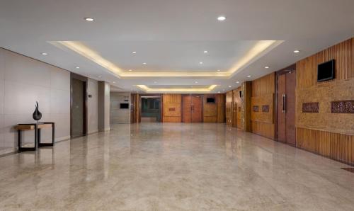 a large lobby with a large room with wooden walls at Hotel Santika Premiere Gubeng Surabaya in Surabaya