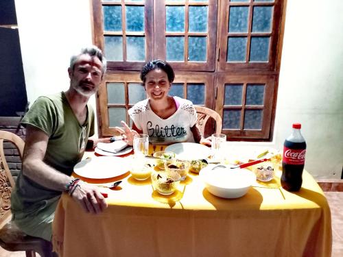 a man and a woman sitting at a table at ARANI HOMESTAY in Polonnaruwa
