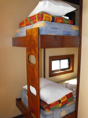 two bunk beds in a room with a mirror at Smugglers Cove Holiday Village in Forster