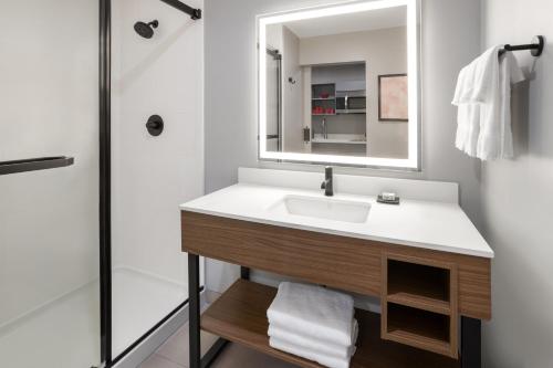 a bathroom with a sink and a mirror at Hawthorn Extended Stay by Wyndham Williston Burlington in Williston