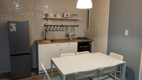 a kitchen with a table and a white table and chairs at Casa Charlotte in San José