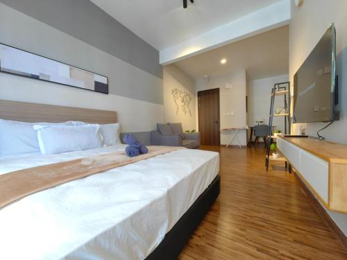 a large bedroom with a large bed with a television at Near Airport K Avenue Family Room in Donggongon