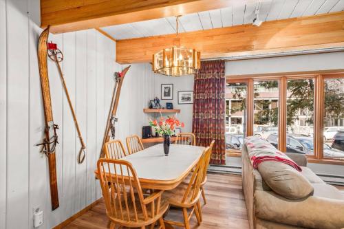 a dining room with a table and a couch at Chateau DuMont 05 in Aspen