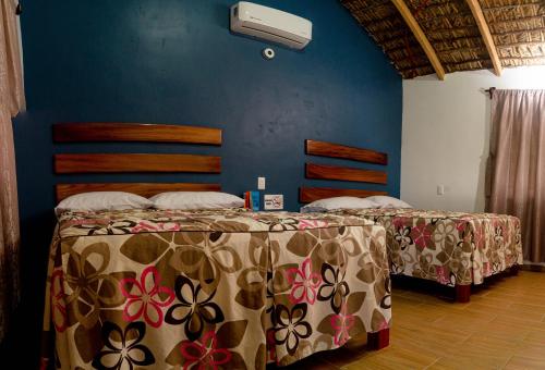 two beds sitting next to each other in a room at CABAÑAS THAJU 