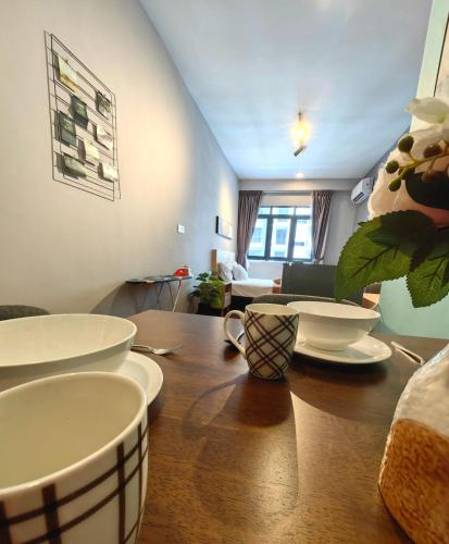 a table with plates and bowls on top of it at Near Airport K Avenue Family Room in Donggongon