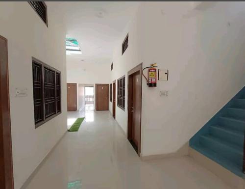 an empty hallway with a staircase in a building at Ramam Hotel by Naavagat Near Ram Mandir in Ayodhya