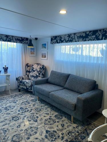 a living room with a couch and a chair at Rainbows End in Redcliffe
