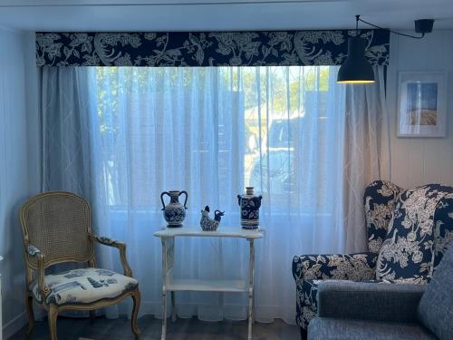 a living room with a table and a window at Rainbows End in Redcliffe