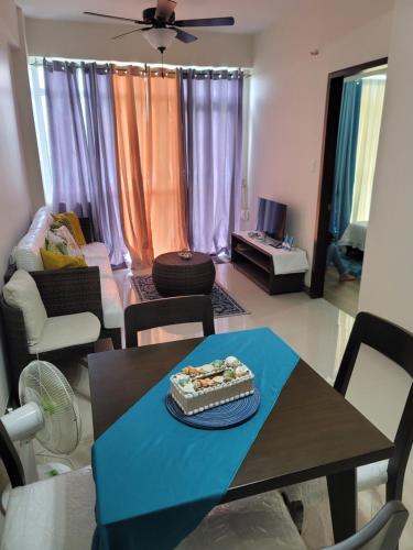 a living room with a table with a cake on it at Ocean Garden Villa Condominium in Boracay
