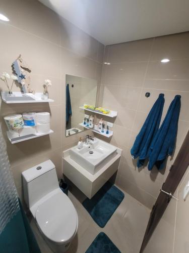 a bathroom with a white toilet and a sink at Ocean Garden Villa Condominium in Boracay