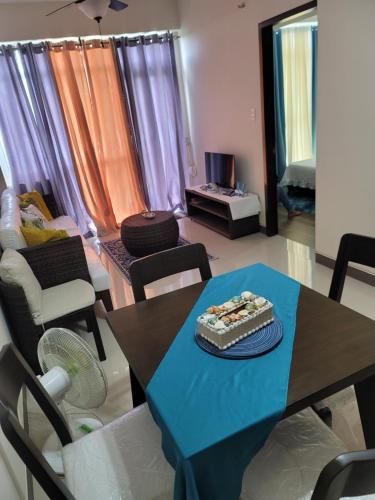 a living room with a table with a cake on it at Newcoast Boracay Top Floor View in Boracay