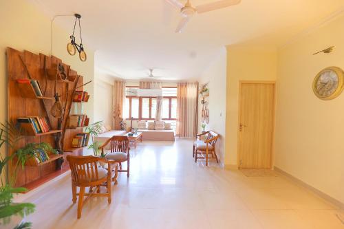 a living room with chairs and a dining room at Soul'Stay- A HomeStay & Retreat Center in Agra
