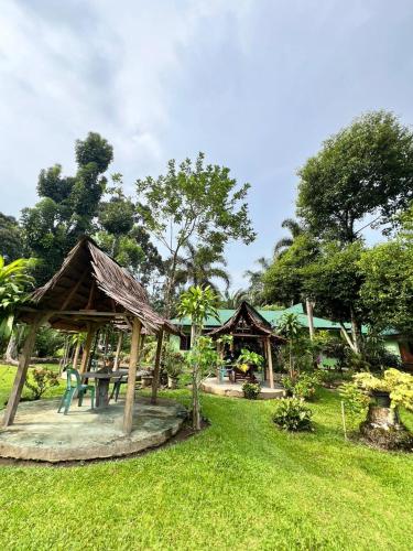 a park with two gazebos and a playground at Wisma Batu Mandi in Bukit Lawang