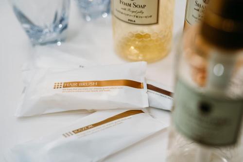 a white table with a bottle of wine and a bag at TAPSTAY HOTEL - Vacation STAY 35238v in Saga