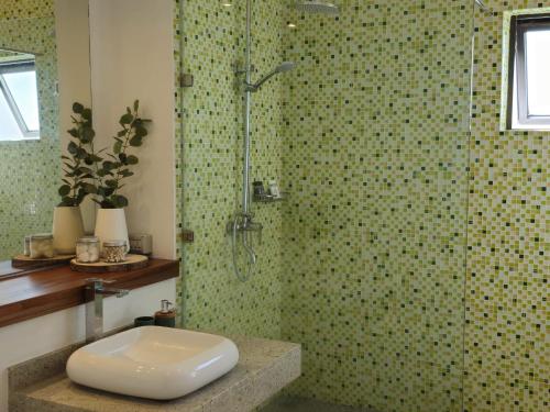 a bathroom with a shower with a toilet and a sink at Modern Villa in Grand Bay - Short Walk to Beach in Grand-Baie