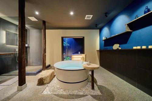 a large bathroom with a tub and a staircase at Kyoto Machiya Zeniyacho in Kyoto