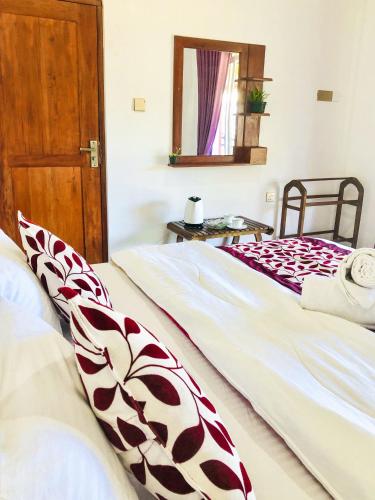 two beds sitting next to each other in a bedroom at Star Holiday Home in Nuwara Eliya