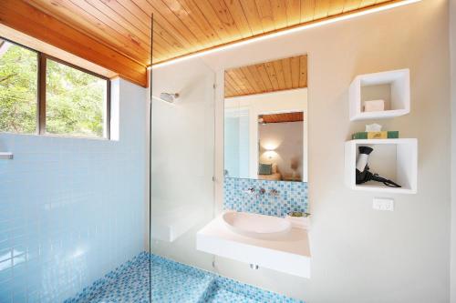 a bathroom with a shower and a toilet and a sink at Tea Trees Apartment 4, Little Cove in Noosa Heads