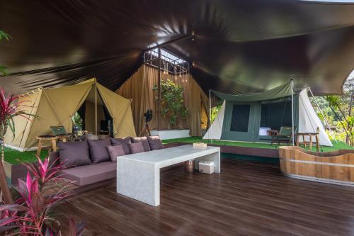 a living room with a couch and a tent at CAMP CAYLA - STELLAR in Chiang Mai