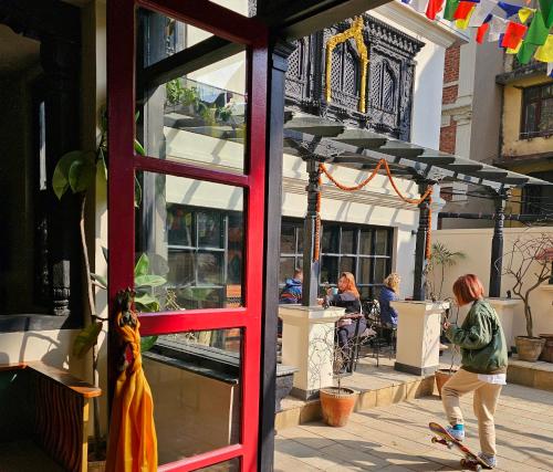 a person riding a skateboard in front of a building at SWARGA HERITAGE HOTEL - A TRADITIONAL STAY in Kathmandu