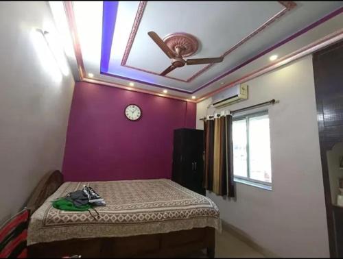 - une chambre avec un lit et un ventilateur de plafond dans l'établissement Aparna sarin park, à Kondapur