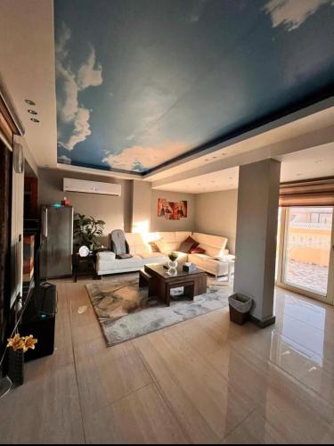 a living room with a couch and a table at Apartment in a villa with pool and garden in Cairo